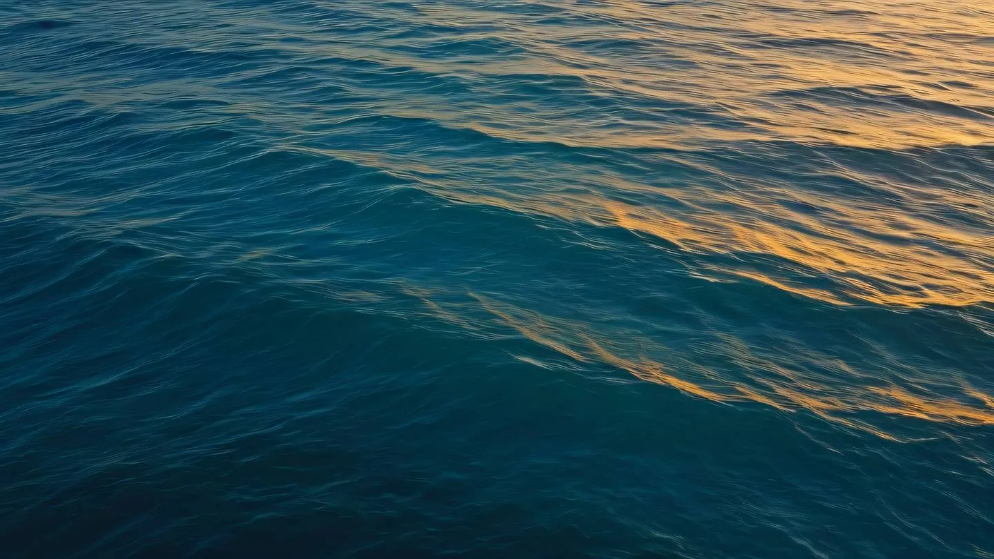 Iridescent ocean waves at sunset minimalist yellow and bright blue colors blending naturally photographed from an aerial perspective high-quality ultra-realistic cinematic 8K UHD high resolution sharp and detail