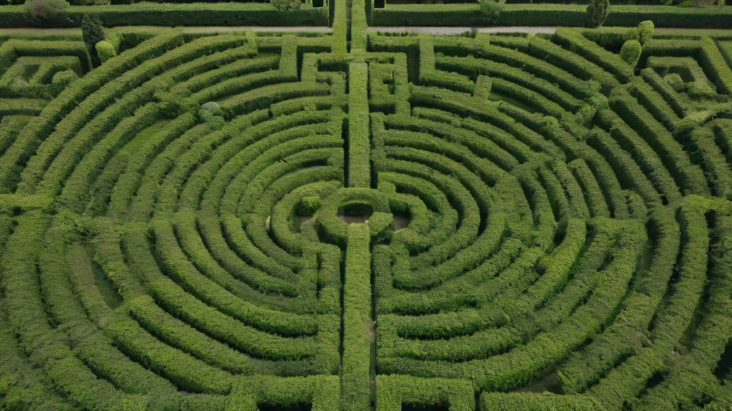 Overhead view of a pristine natural maze formed by hedges in bright neutral beige and olive green colors photographed from directly above with perfect symmetry high-quality ultra-realistic cinematic 8K UHD high resolution sharp and detail