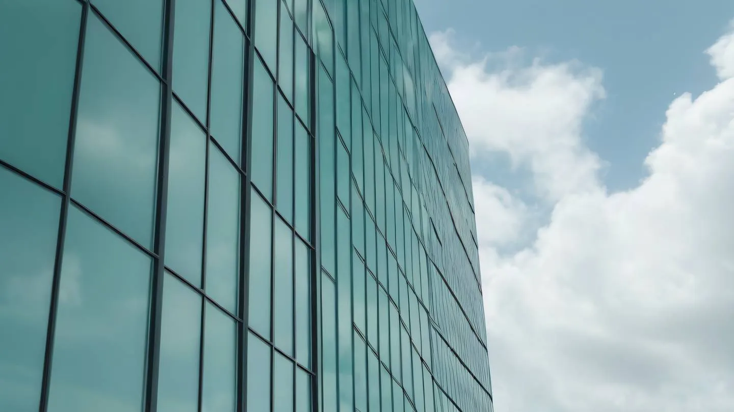 A modern minimalist architectural facade with clean lines and geometric patterns featuring large glass windows reflecting clouds. Color palette: Bright sage green and white. Camera angle: Low angle shot looking upward emphasizing the building's height and grandeur. Style: high-quality ultra-realistic cinematic 8K UHD high resolution sharp and detail