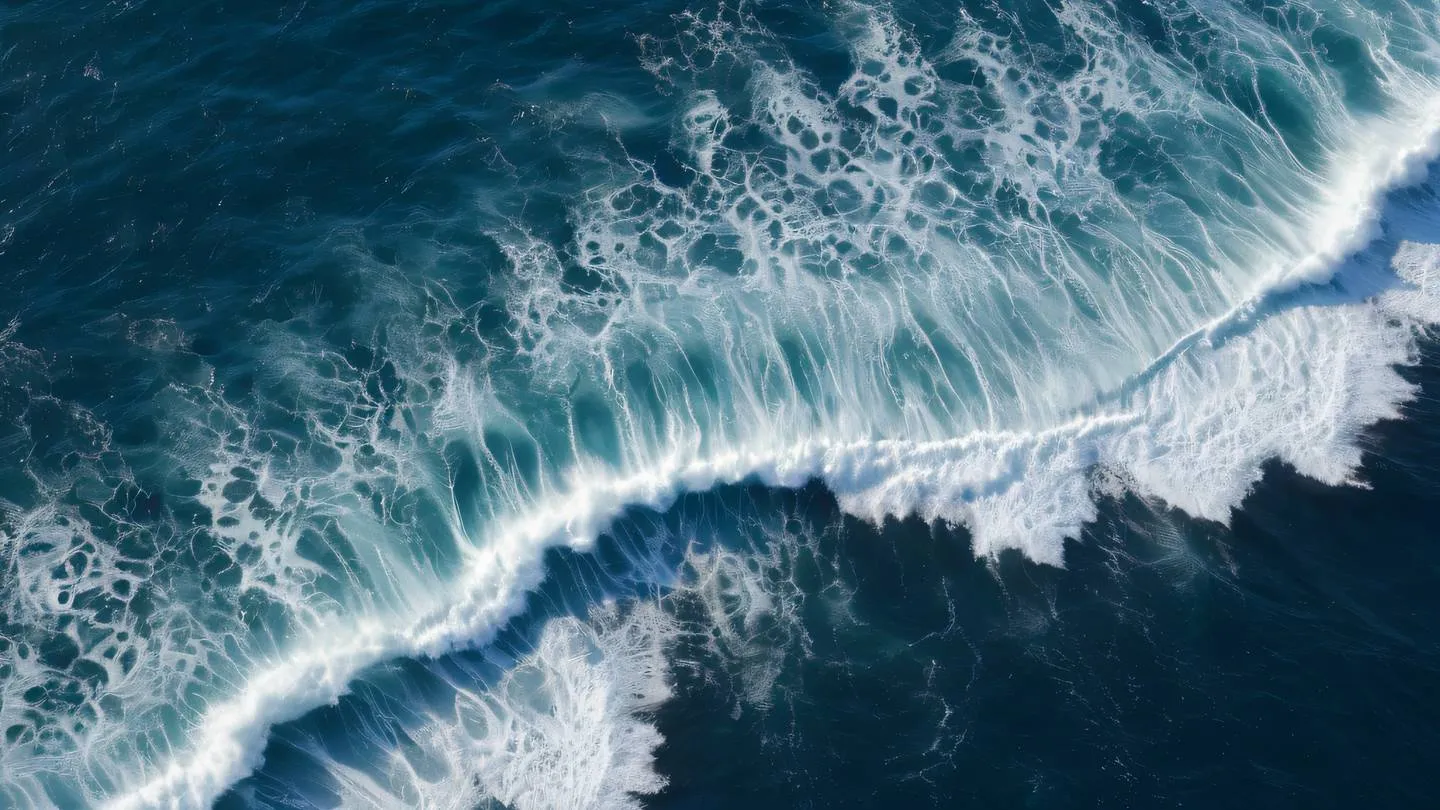 Aerial view of ocean waves creating intricate patterns featuring deep blue and white foam textures captured from directly above high-quality ultra-realistic cinematic 8K UHD high resolution sharp and detail