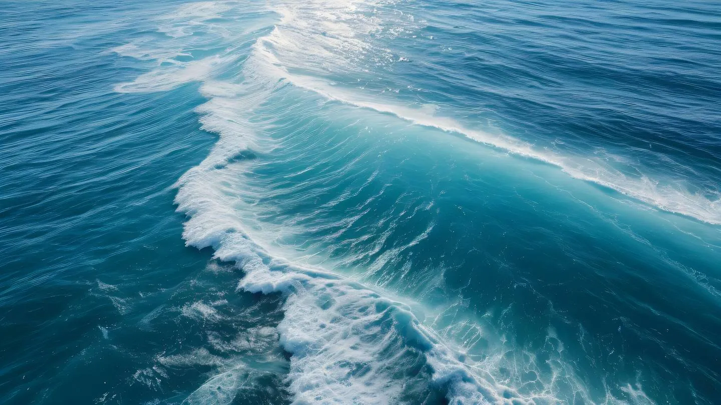 Aerial top-down view of ocean waves creating circular patterns dominant colors: bright azure blue and white foam captured from high altitude with strong directional sunlight high-quality ultra-realistic cinematic 8K UHD high resolution sharp and detail