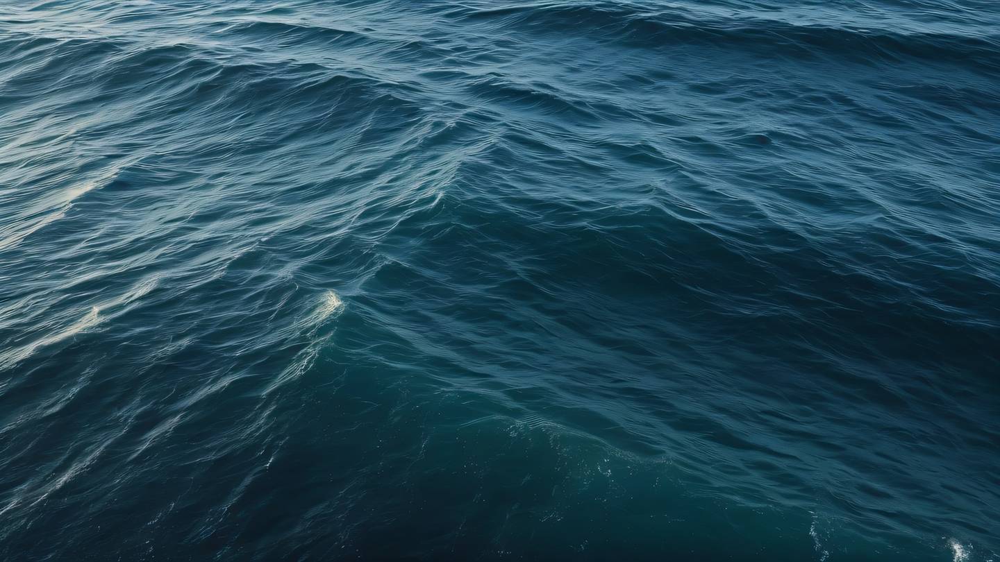 Ocean waves creating natural patterns and textures in dusty blue and off-black colors aerial camera angle high-quality ultra-realistic cinematic 8K UHD high resolution sharp and detail